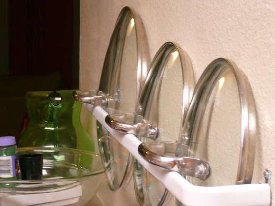Use a towel rack to hold pot lids